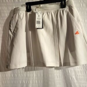 NWT Adidas golf or tennis skort. Front pockets.  White.  Orange logo. Size Small